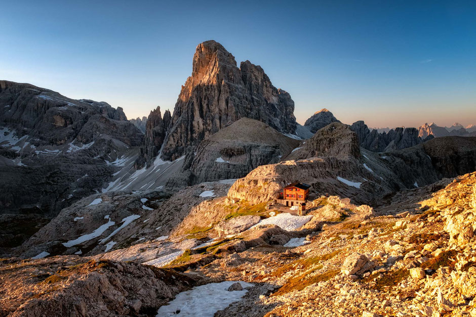 12 Things You Need To Know Before Staying In A Mountain Hut In The Italian Dolomites 5 The tiny Buellelejochhuette dwarfed by the Zwölferkoffel in the Tre Cime National Park. Guide to staying in the mountain huts in the Italian Dolomites