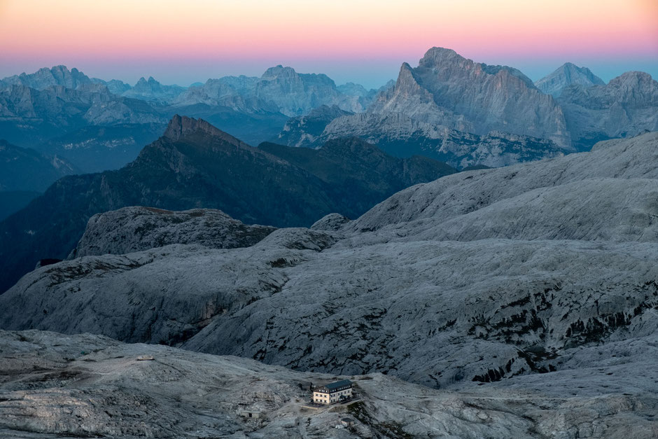 Rifugio Rosetta at dusk from the summit of Mount Rosetta. Monte Civetta can be seen in the distance 