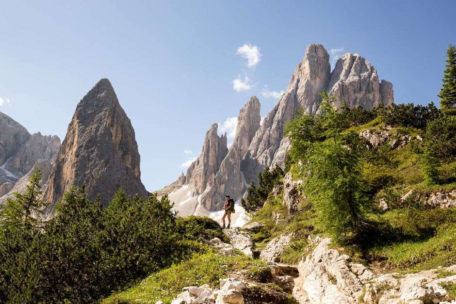 A hiker on a trail in the Tre Cime National Park in the Italian Dolomites