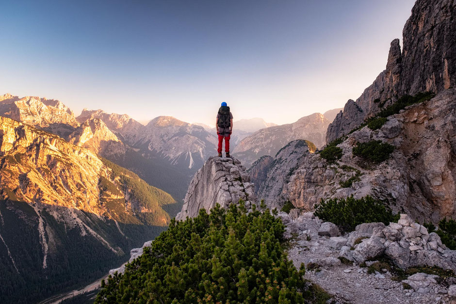 Top Via Ferratas Around Cortina d'Ampezzo In The Italian Dolomites 7 Climber standing on the top of an outcrop with the morning views of the Italian Dolomites. Via ferrata Michielli Strobel near Cortina D'ampezzo