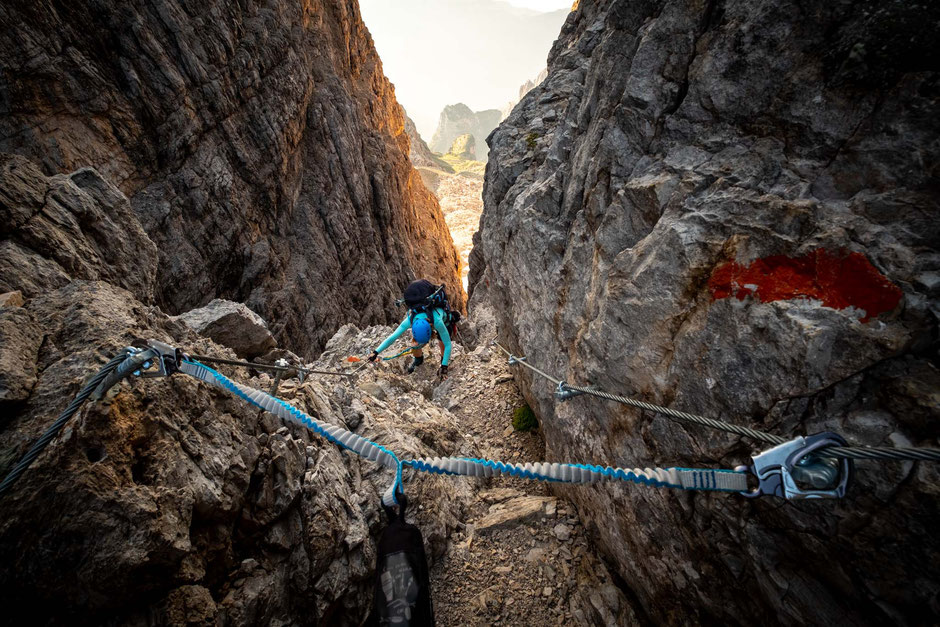 A climber in a narrow gully on the via ferrata Bocchette Alte in the Brenta Dolomites