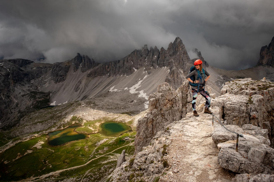 A climber on the summit of Torre di Toblin after completing her first via ferrata